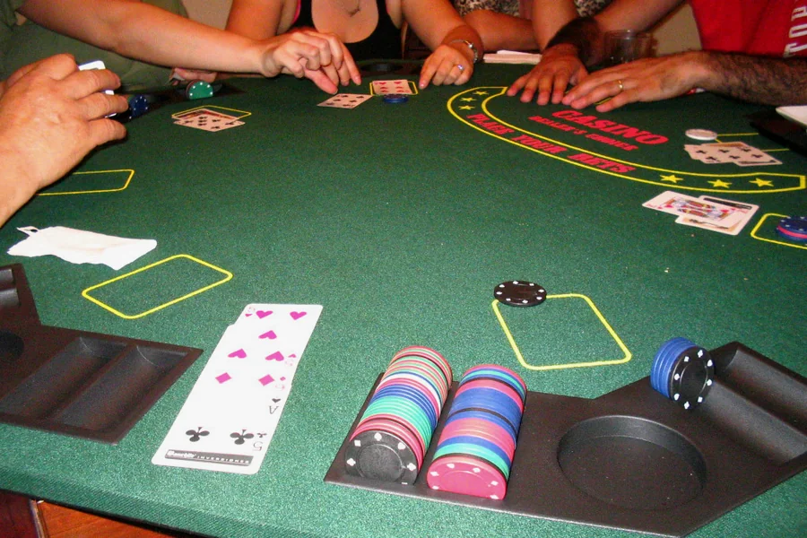 A poker table mid-hand: cards face down, chips in the pot