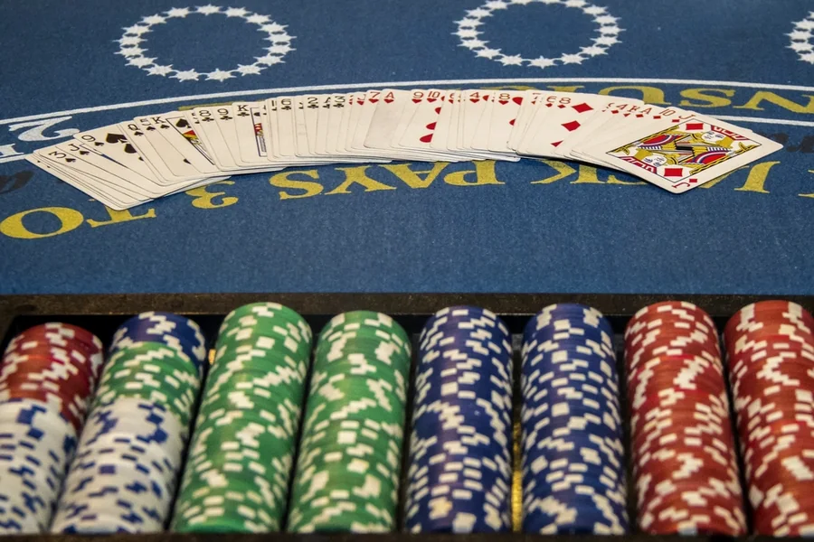 A blackjack layout with a fanned deck and a tray of chips