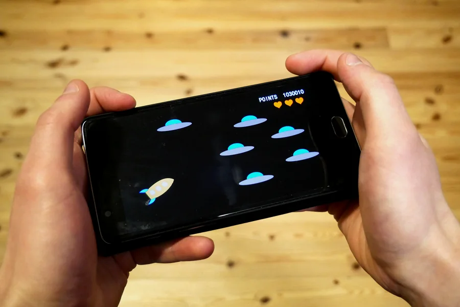 A game running on a smartphone held in both hands