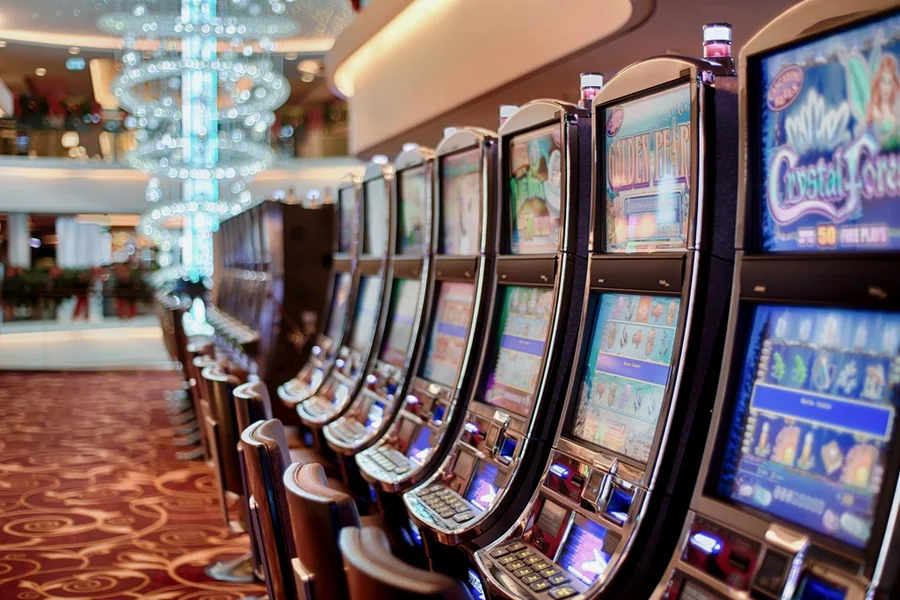 A row of slot machines lit up on a casino floor